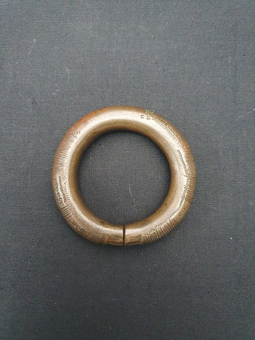 Antique African bronze manilla with intricate detail.