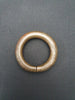 Antique African bronze manilla with intricate detail.